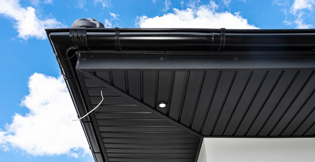 Modern roof edge with black drainage system